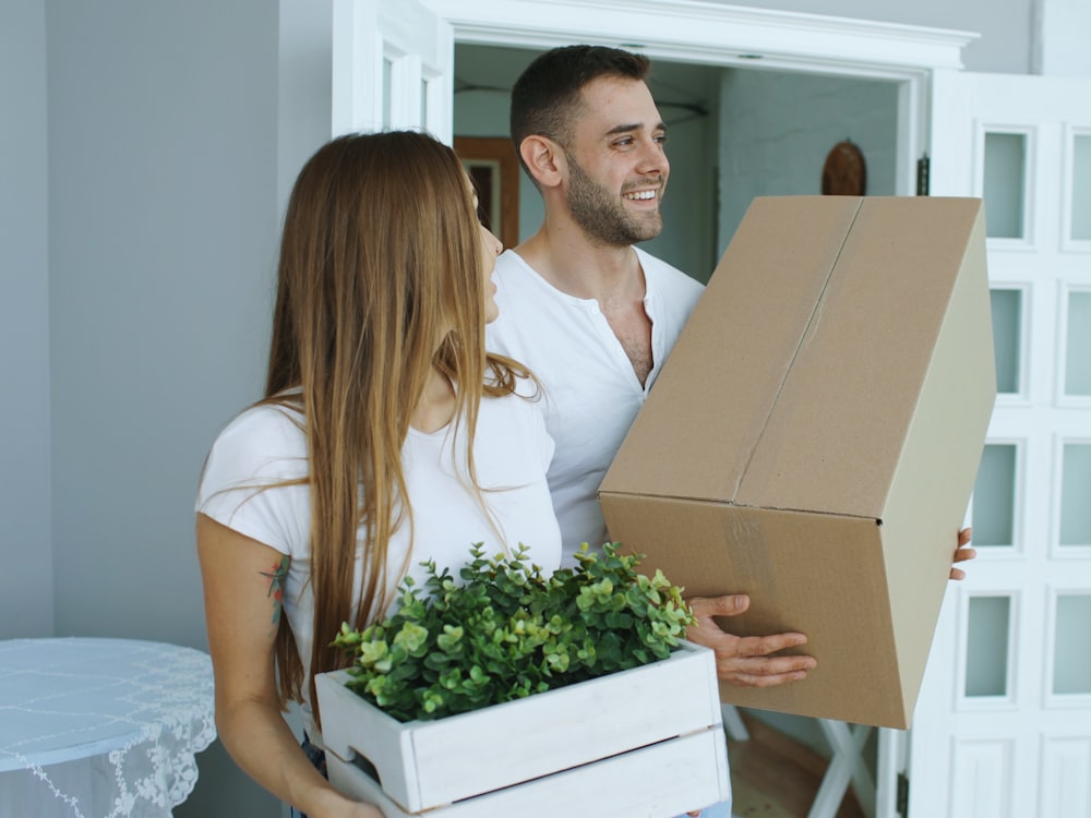A StrongBox team member and a client together in a hallway with labelled boxes ready to go