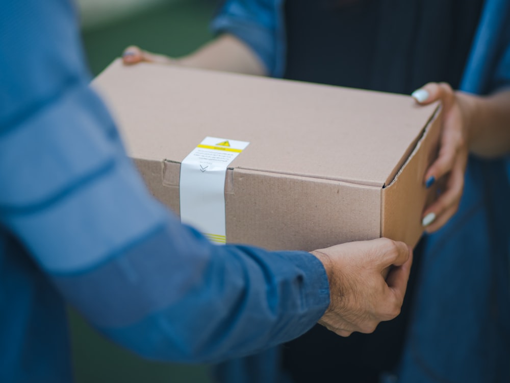 A client signing for their delivered boxes on a StrongBox driver's tablet at their front door